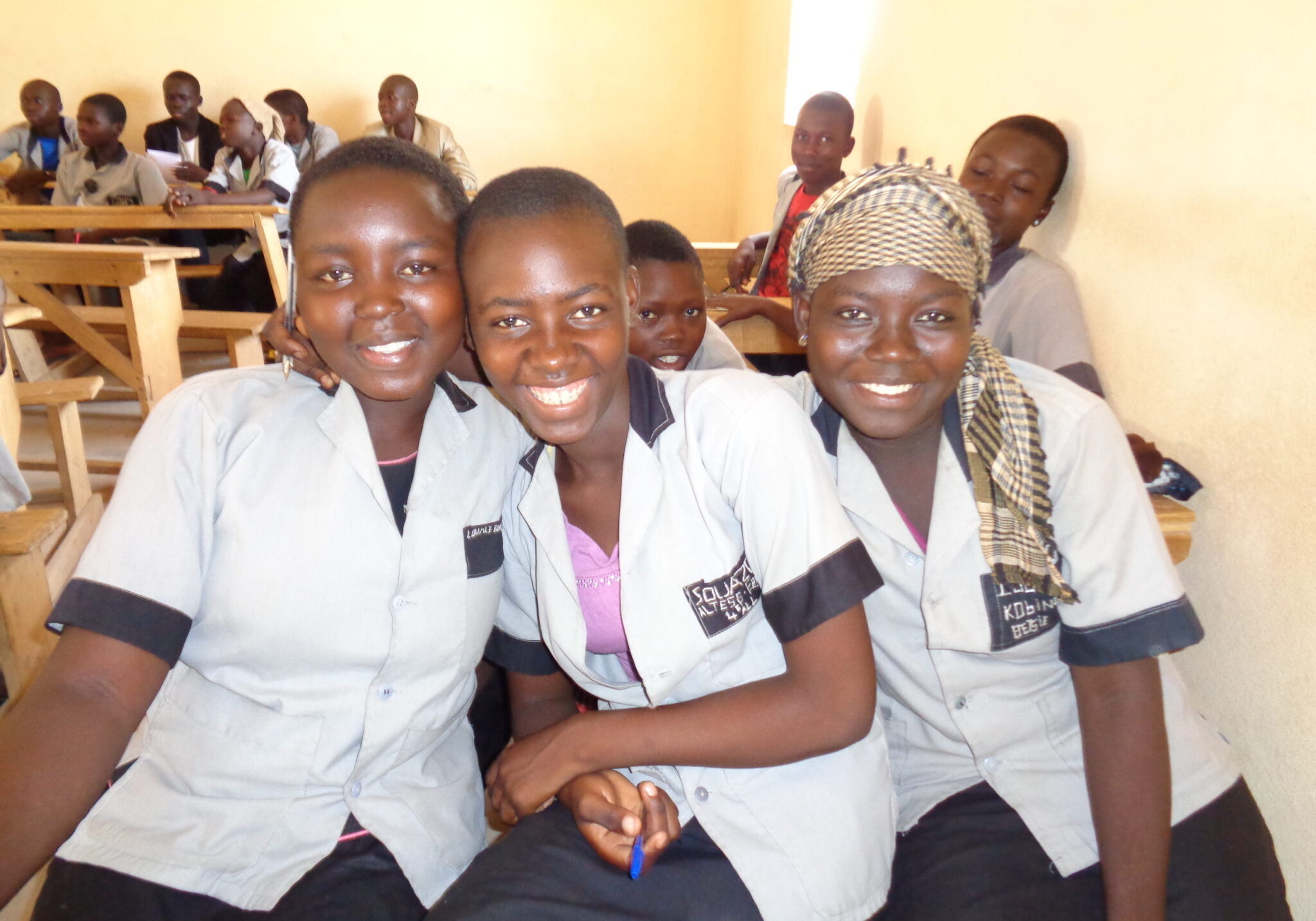 A group of students sitting together and smiling